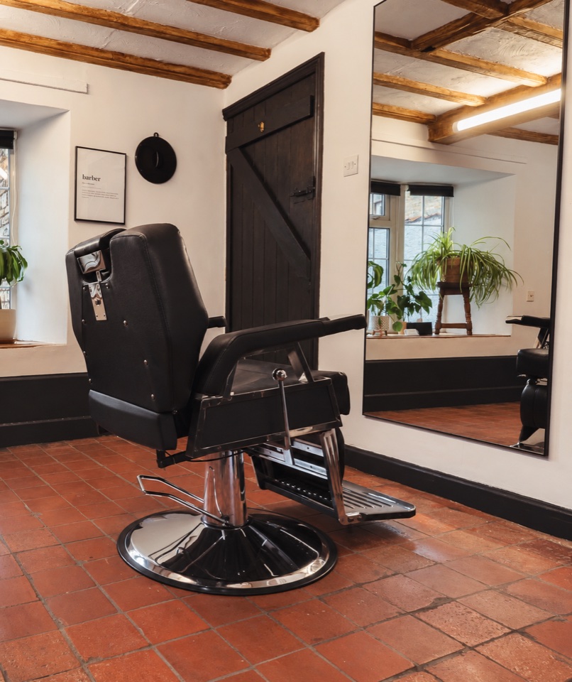 Inside Rhiannon’s studio: a black barber chair, timber beams, plants and terracotta tiles